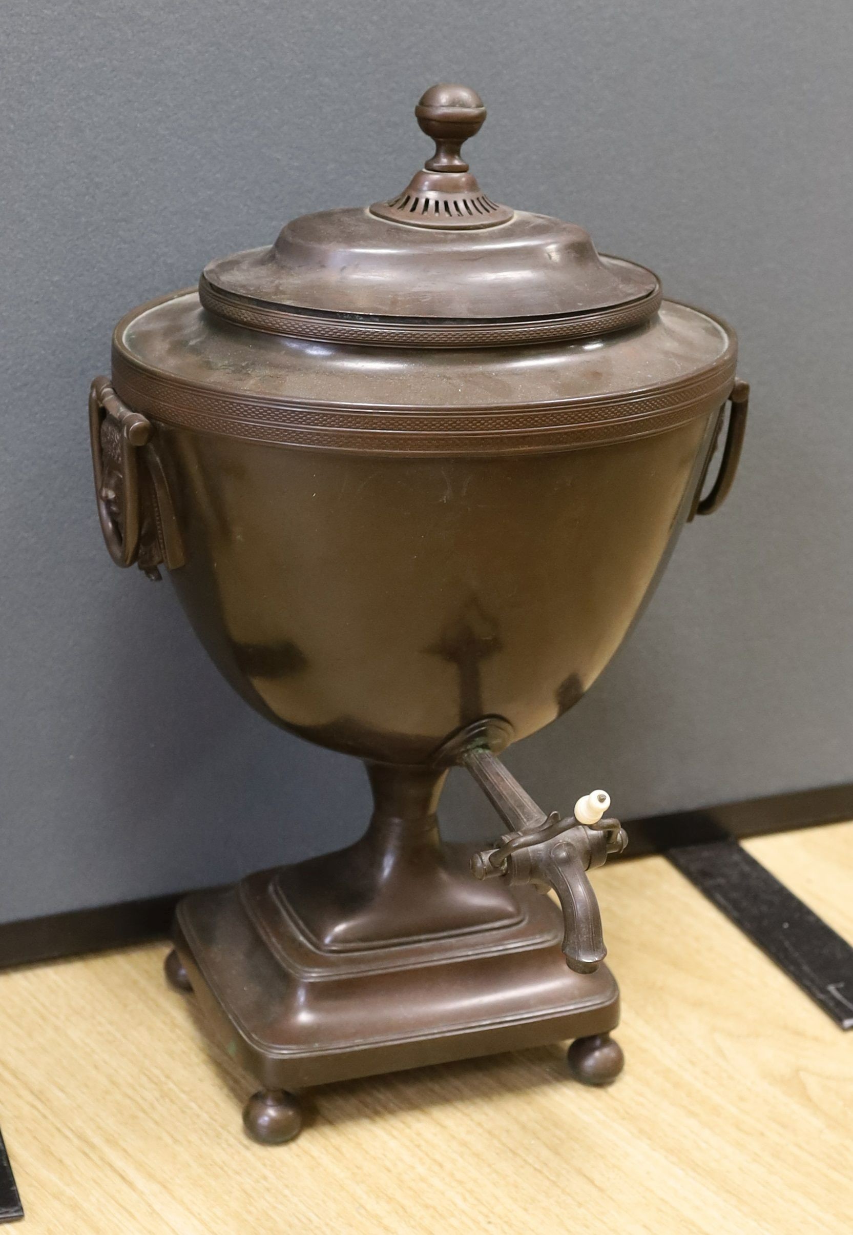 After Alex Decaix - A Regency copper tea urn, with classical caryatid mask and ring handles, 48 cms high.